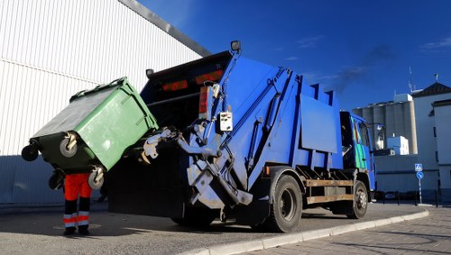 Waste removal truck collecting garbage in Stokenewington